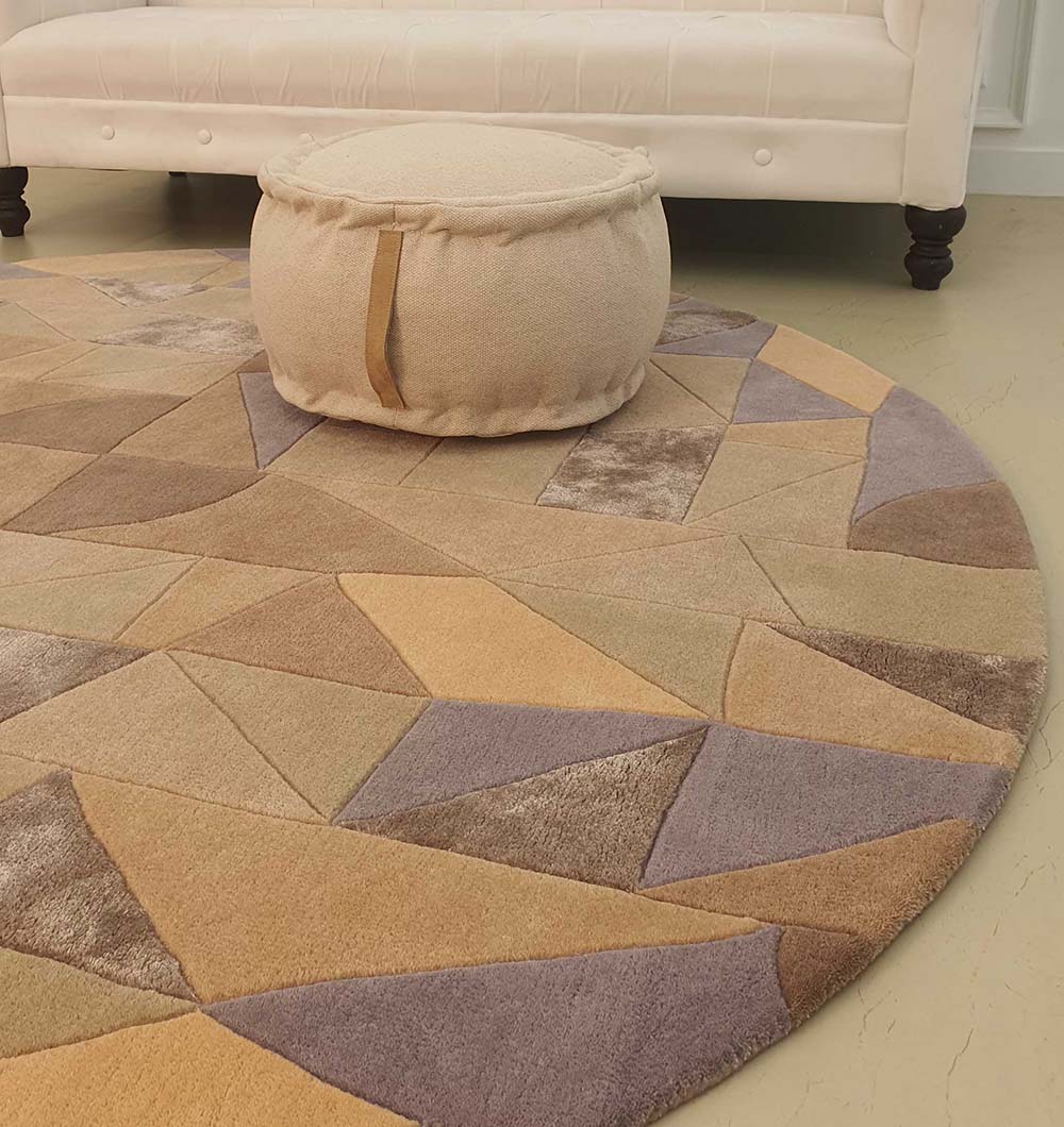 Round area carpet with a pouf placed on top, showing its versatile use and stable foundation for paired furniture.