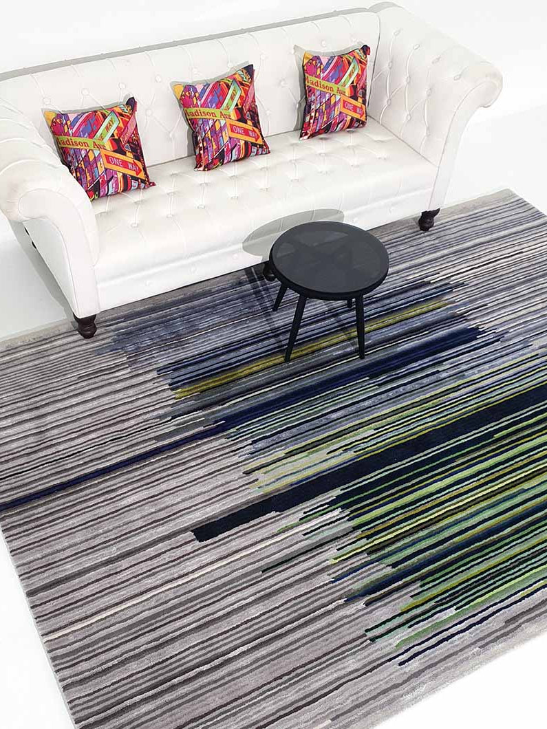 Rectangular multi-color rug placed in a living space, acting as a functional room anchor with its rich palette.