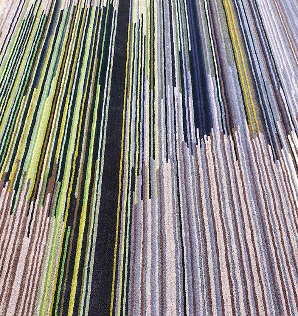 Close-up image detailing the complex pattern and varied color arrangement of the tufted surface.