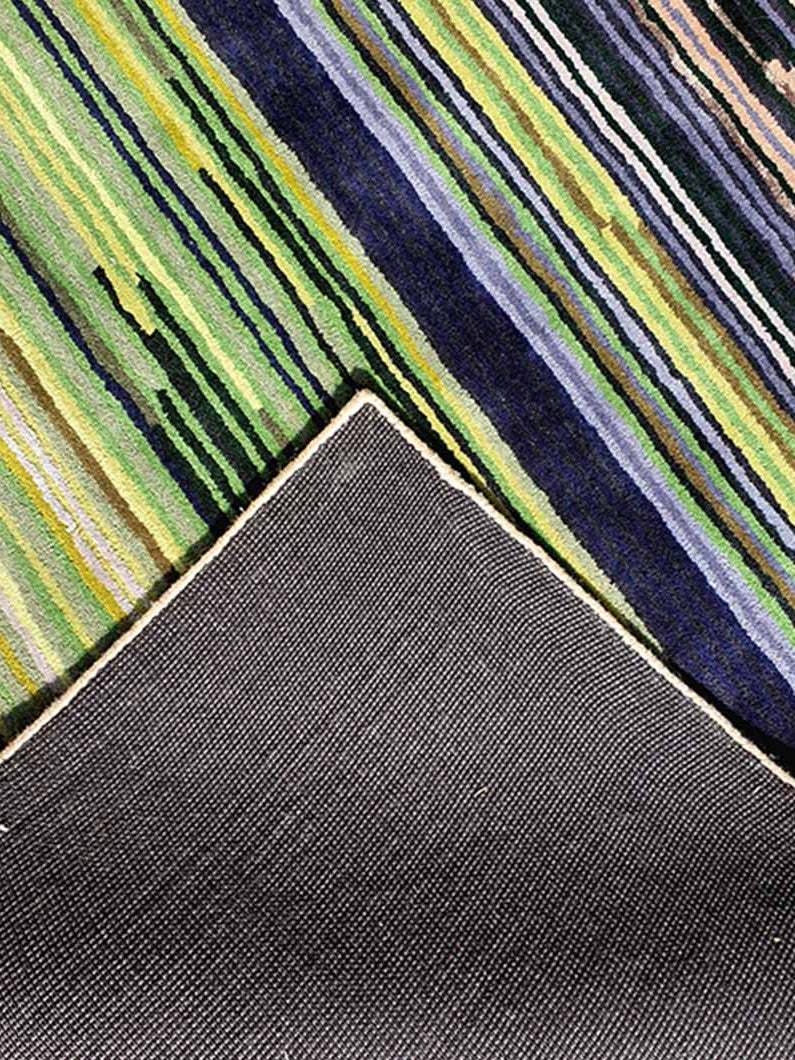 Backside of the multi-color rug, confirming the sturdy secondary backing and handmade construction quality.