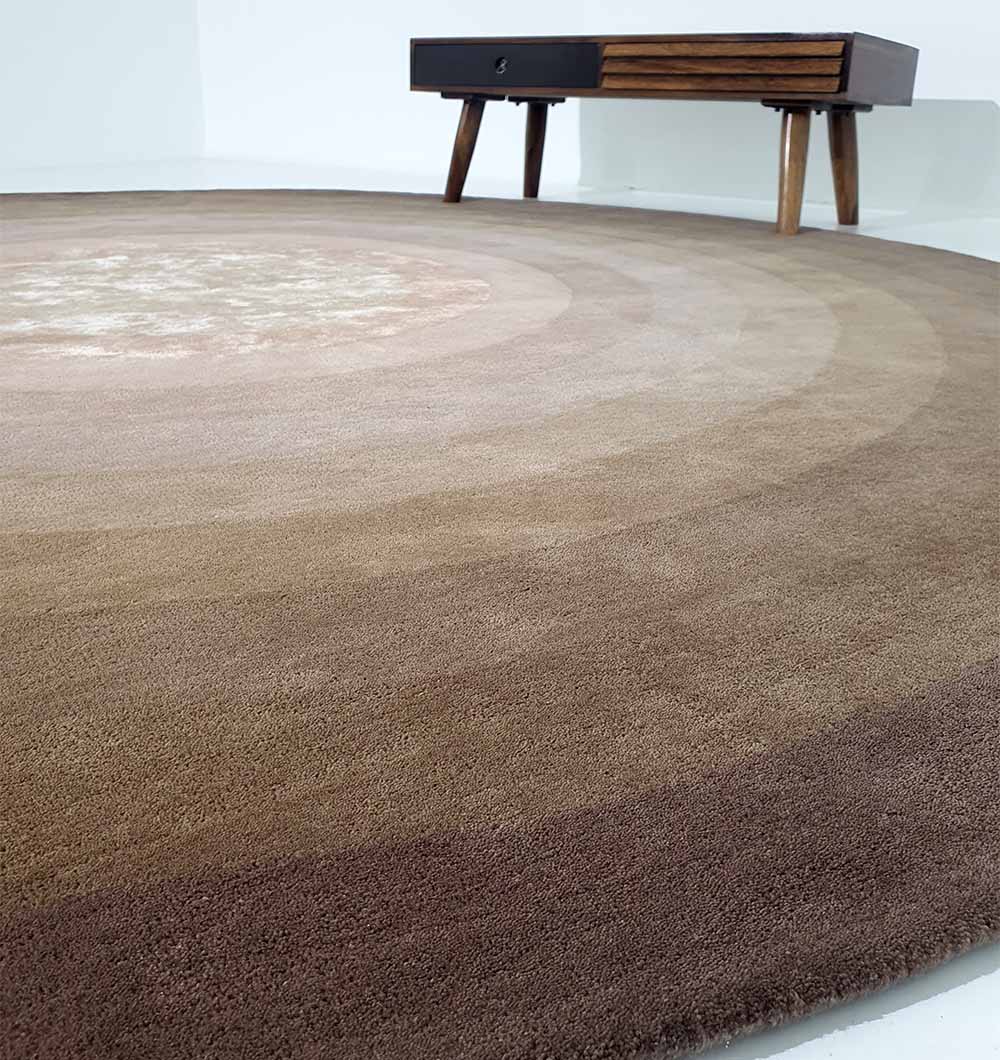 Full view of the large round rug anchoring an open floor plan, acting as a contemporary accent and elegant centerpiece.