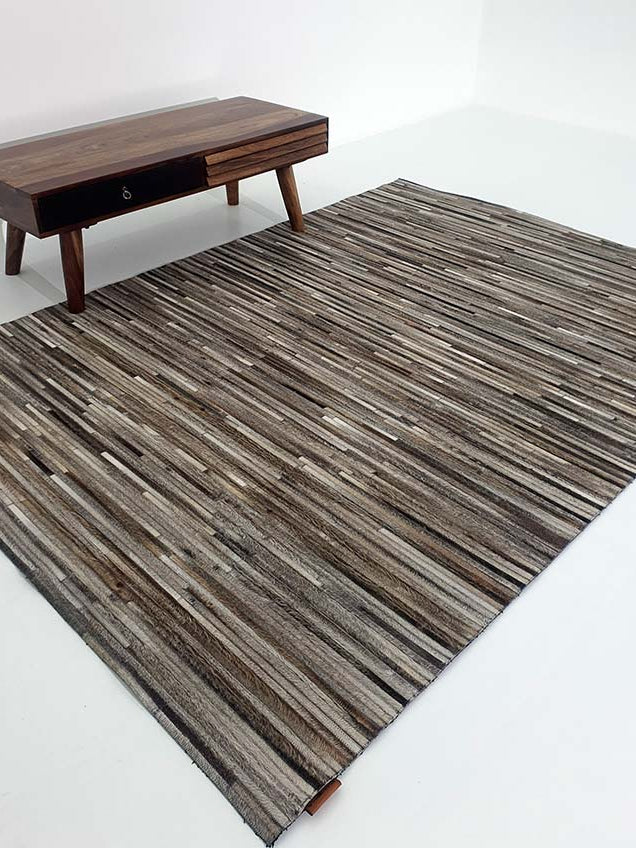Rectangular leather and wool rug in home decor, functioning as a hard-wearing room foundation with a layered build.