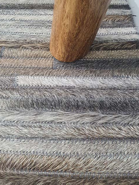 Close-up image detailing the looped weave structure and custom crafted stitching of the leather and wool materials.