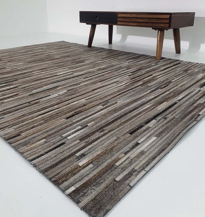 Handmade leather rug LR-013 in multicolor design placed in a modern living room with sofa and coffee table