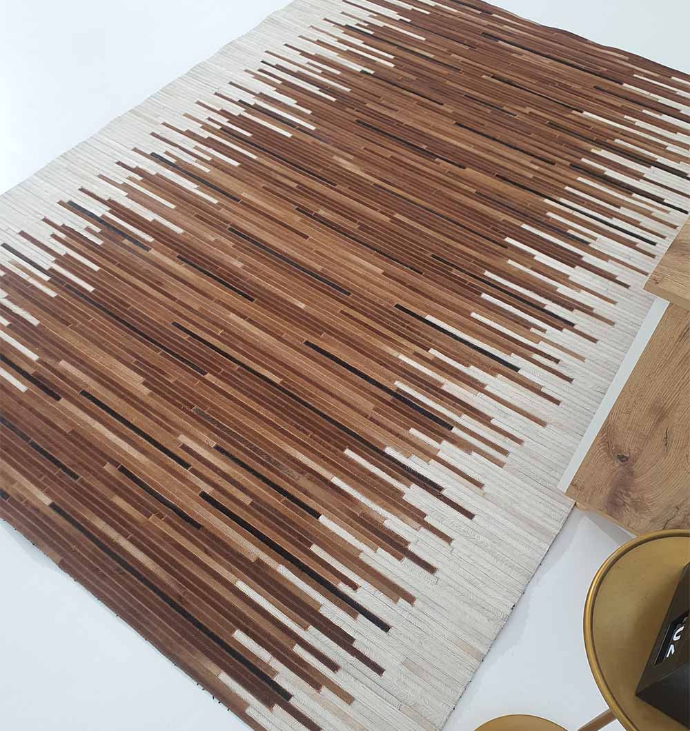 Handcrafted leather area rug in multicolor tones adding texture and warmth to a minimalist bedroom interior