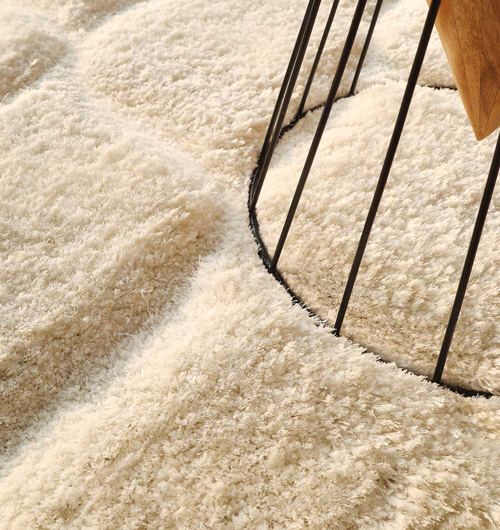 Detailed shot focusing on the plush surface and superior softness of the rectangular white shaggy floor covering.