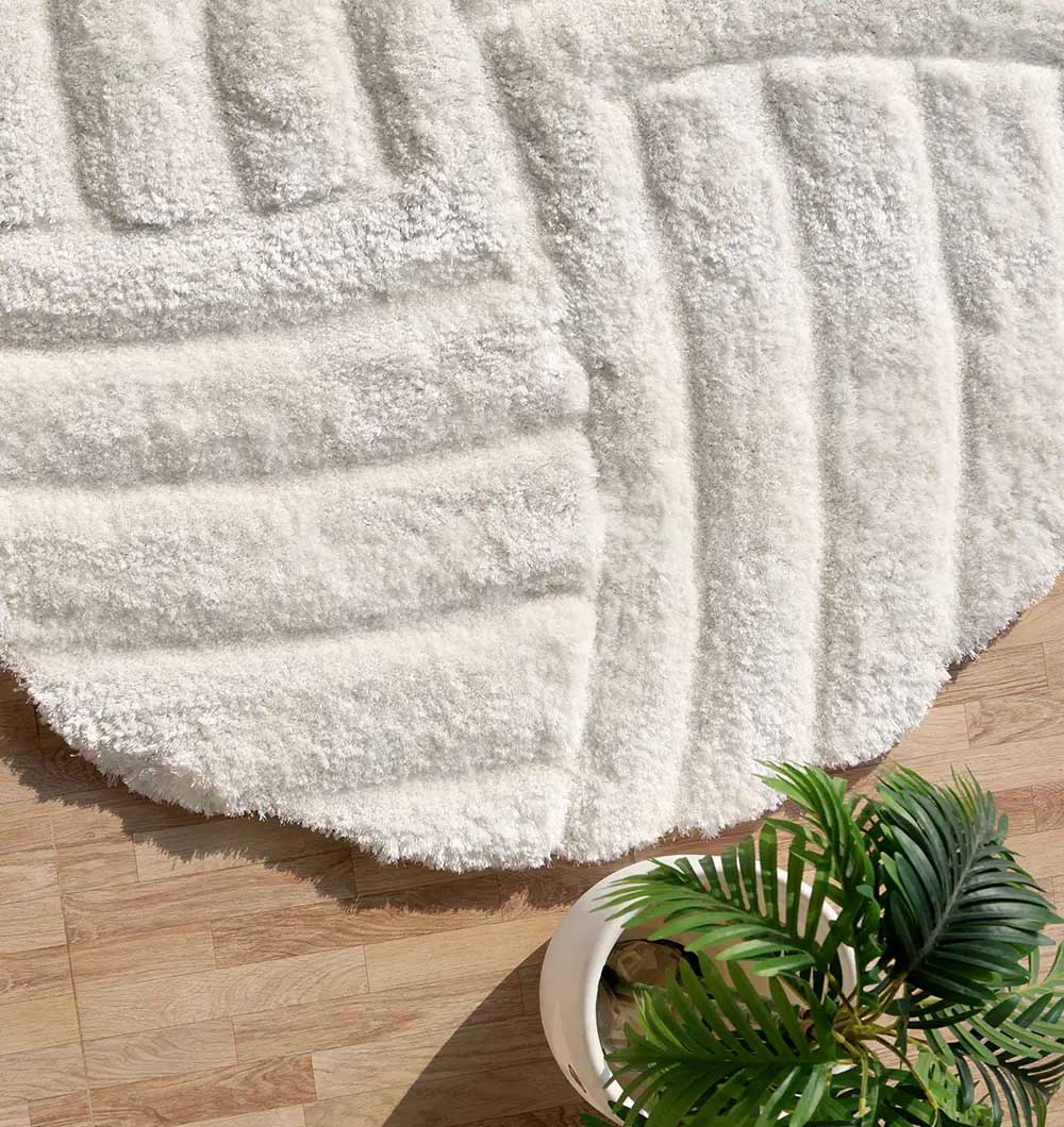 Side close-up highlighting the dense plush texture and soft $80\%$ polyester blend of the round luxury shaggy rug.