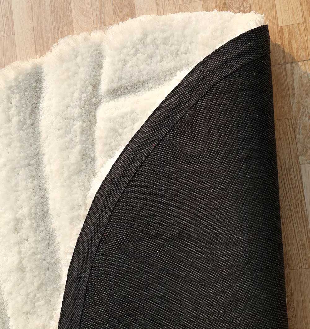 Backside of the round shaggy rug, confirming the high-quality handmade construction and durable backing.