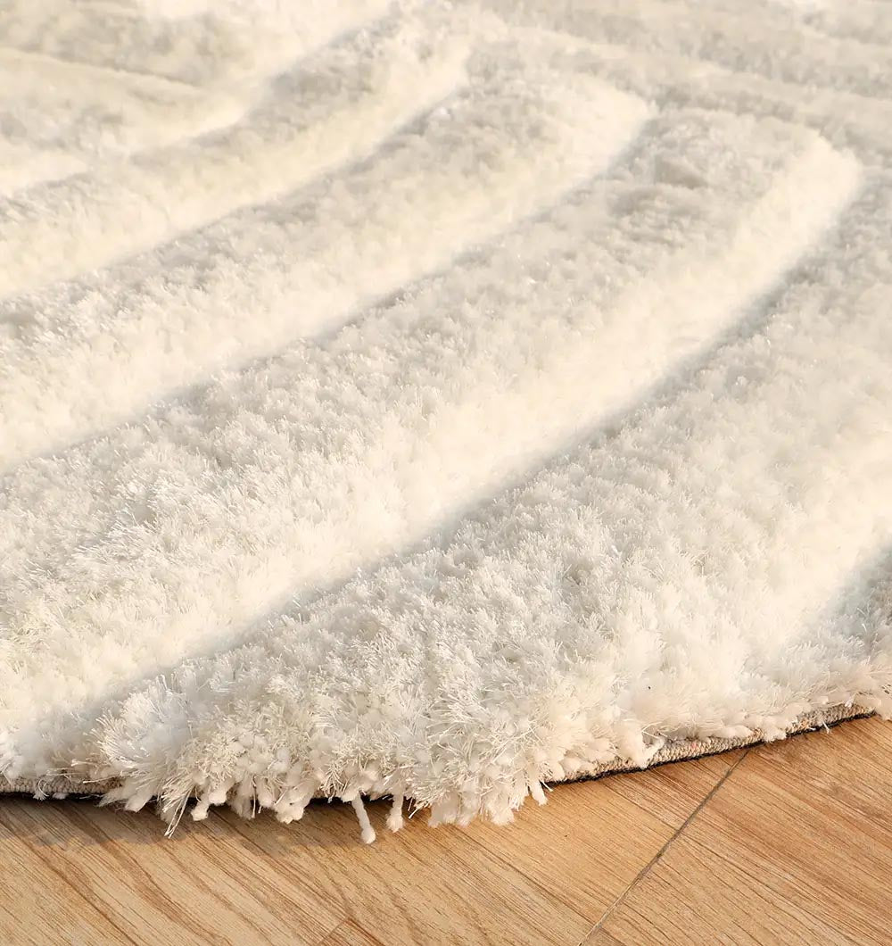 Detailed side view emphasizing the ultra-soft pile height designed for comfort in the bedroom or living area.