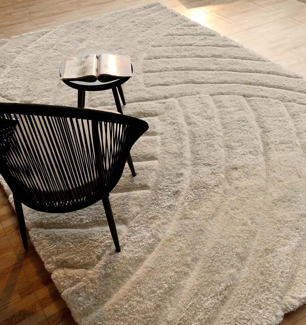 Side angle of the rectangular shaggy rug with decor, highlighting its chic aesthetic and versatile backdrop for the room.