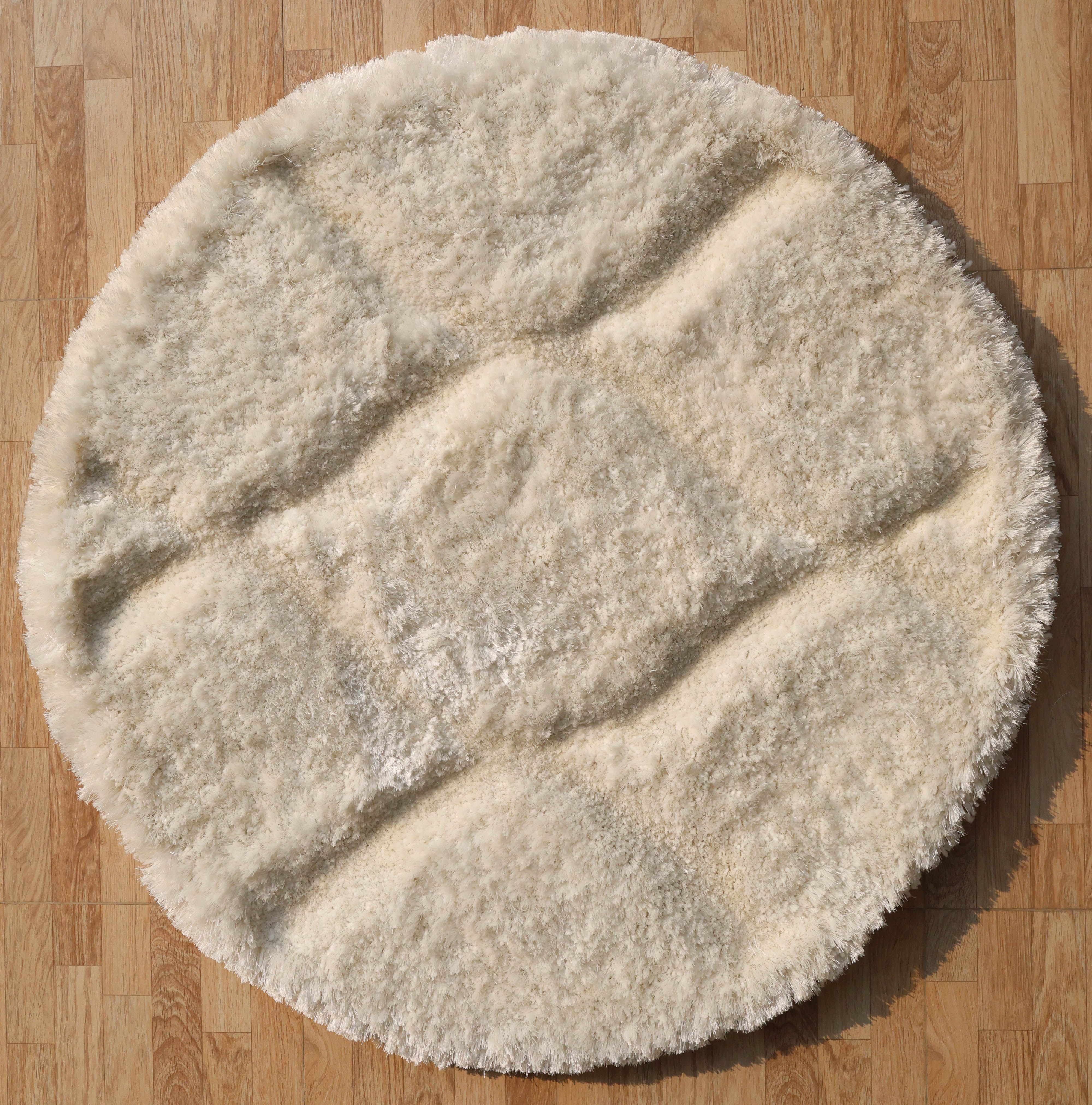 Overhead view showcasing the full round shape and timeless elegance of the white shaggy carpet.