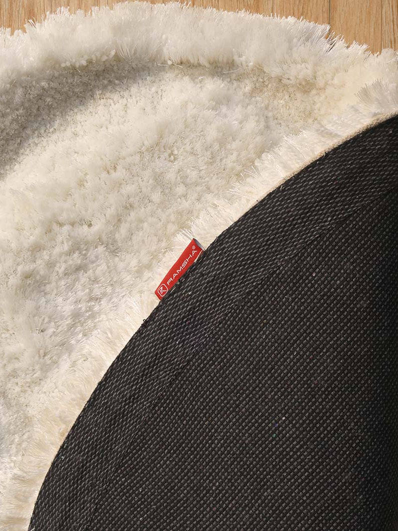 Backside of the cream round luxury shaggy rug, confirming the durable backing and expert handmade construction.