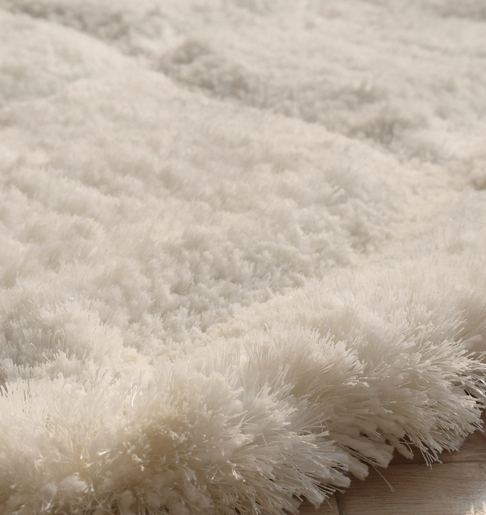 Angled view of the handmade luxury round carpet, treating feet to ultimate comfort and style.