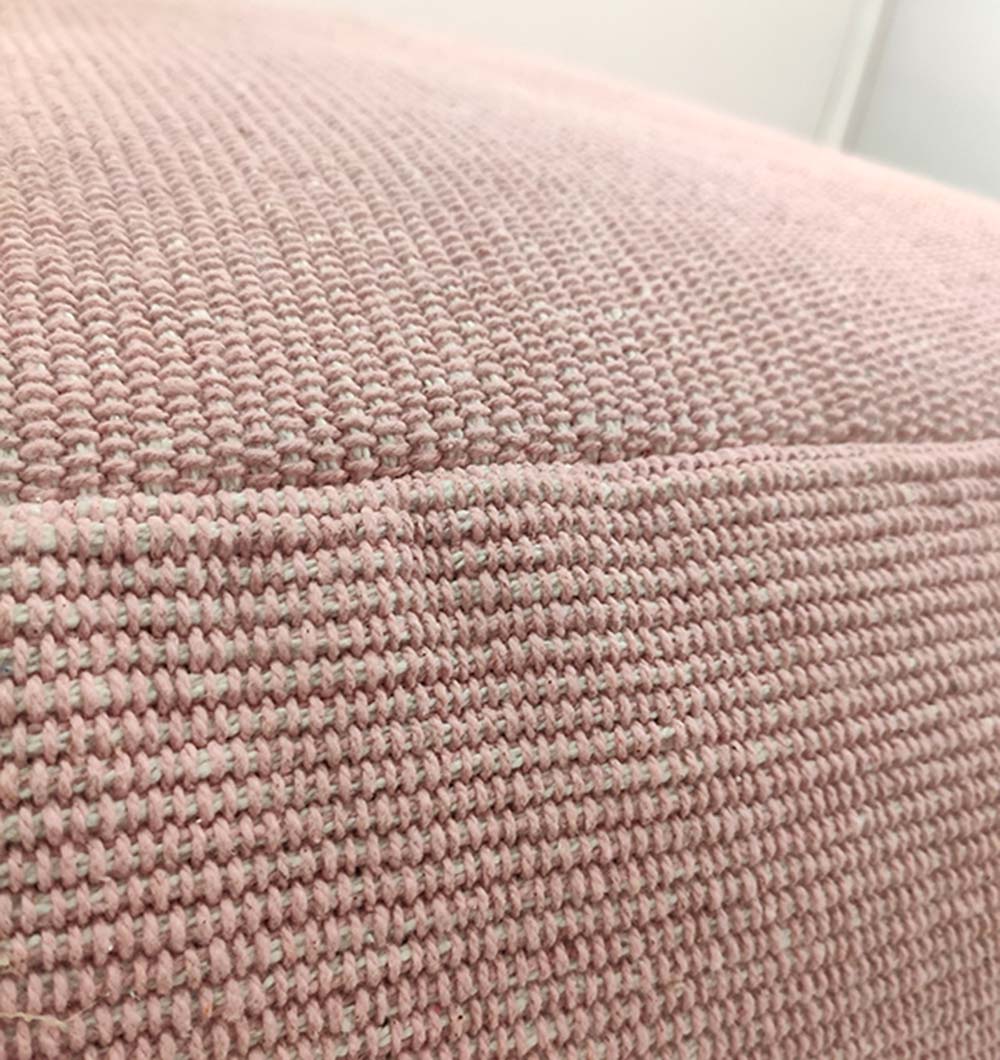 Close-up of handmade pink cotton pouf showing detailed woven texture and soft cotton fabric finish.
