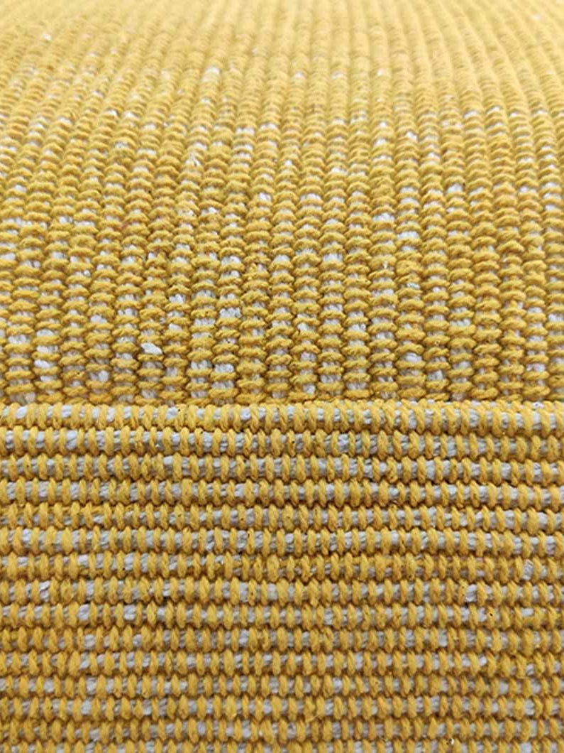 Detailed view of yellow cotton pouf highlighting the intricate handmade weave and high-quality craftsmanship.