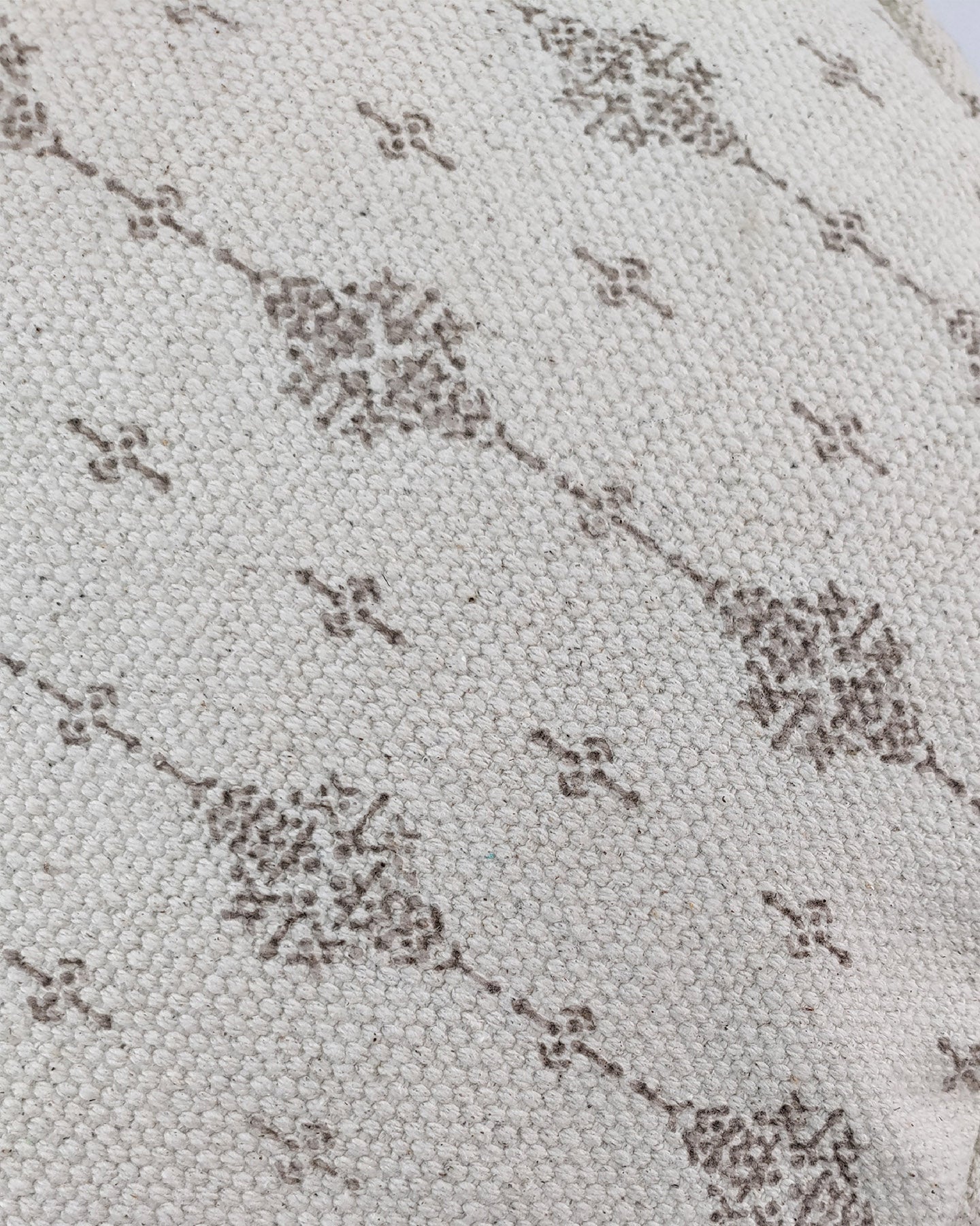 Detailed image highlighting the intricate weave and fringe detailing of the white and grey cotton pouf.