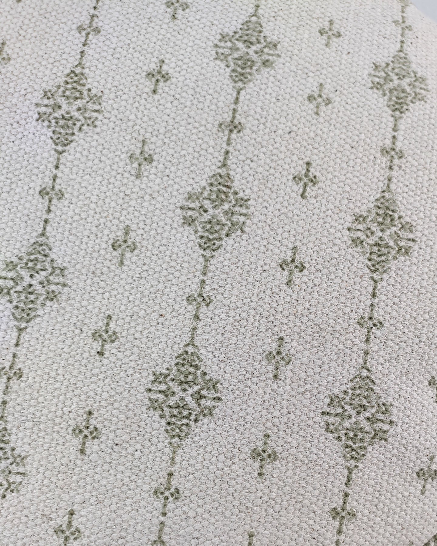 Detailed shot showing the textured surface and color contrast of the white and green cotton pouf with elegant fringes.