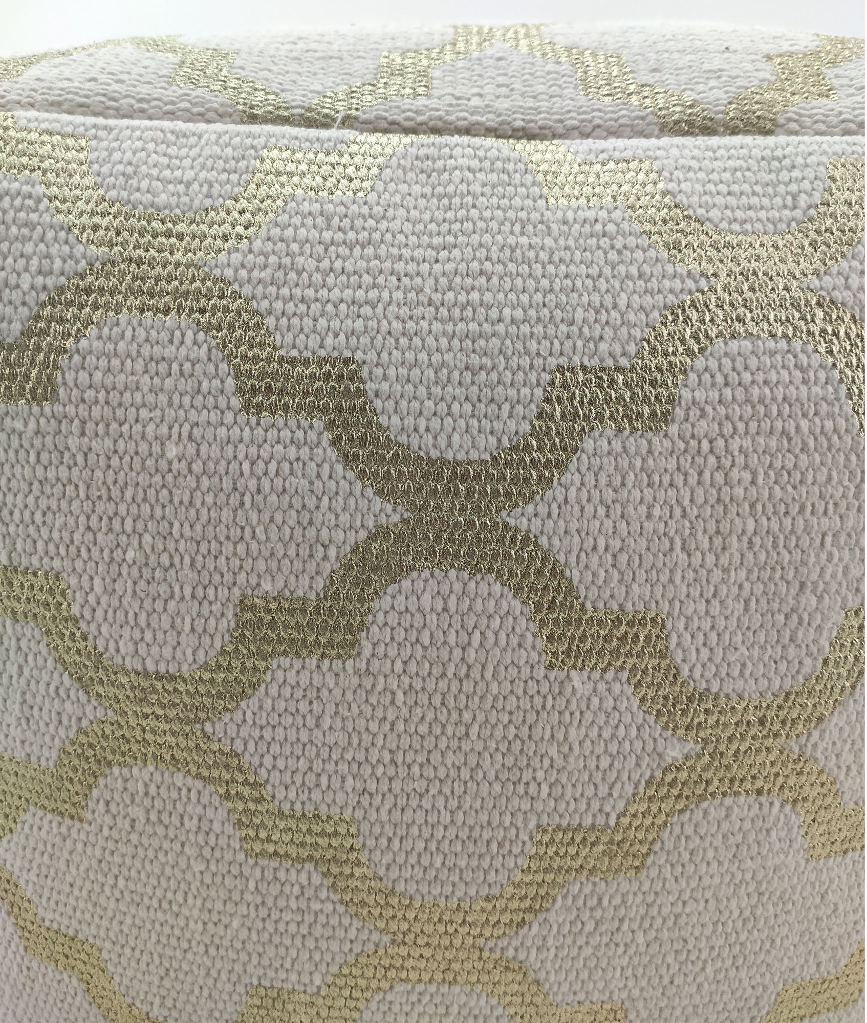Zoomed-in shot of the elegant white and gold pouf highlighting its intricate handmade pattern and premium cotton material.