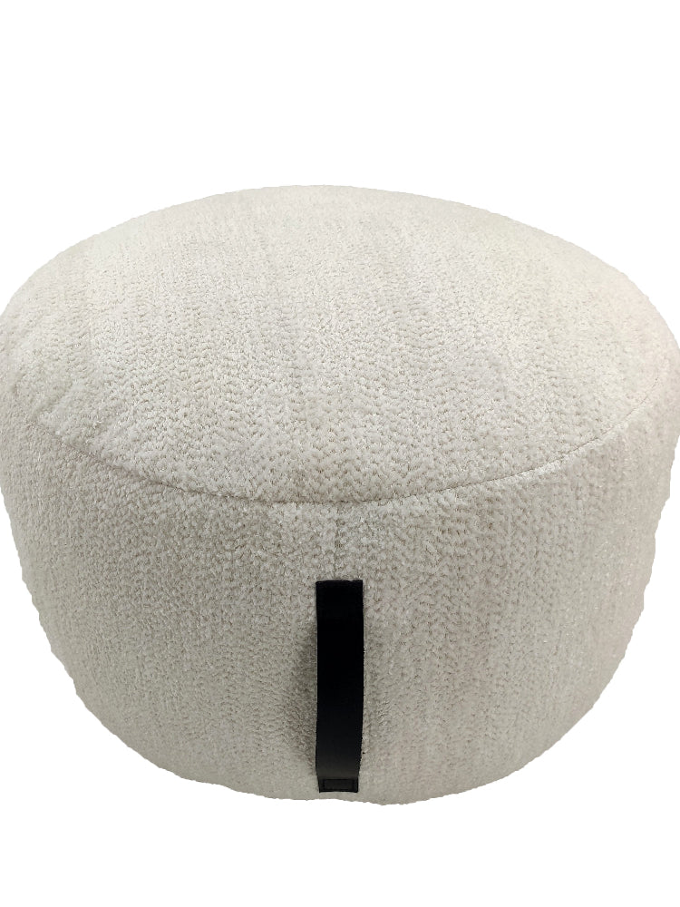Handmade white cotton pouf with sturdy side handle, featuring soft textured fabric and a cozy round design for modern interiors.