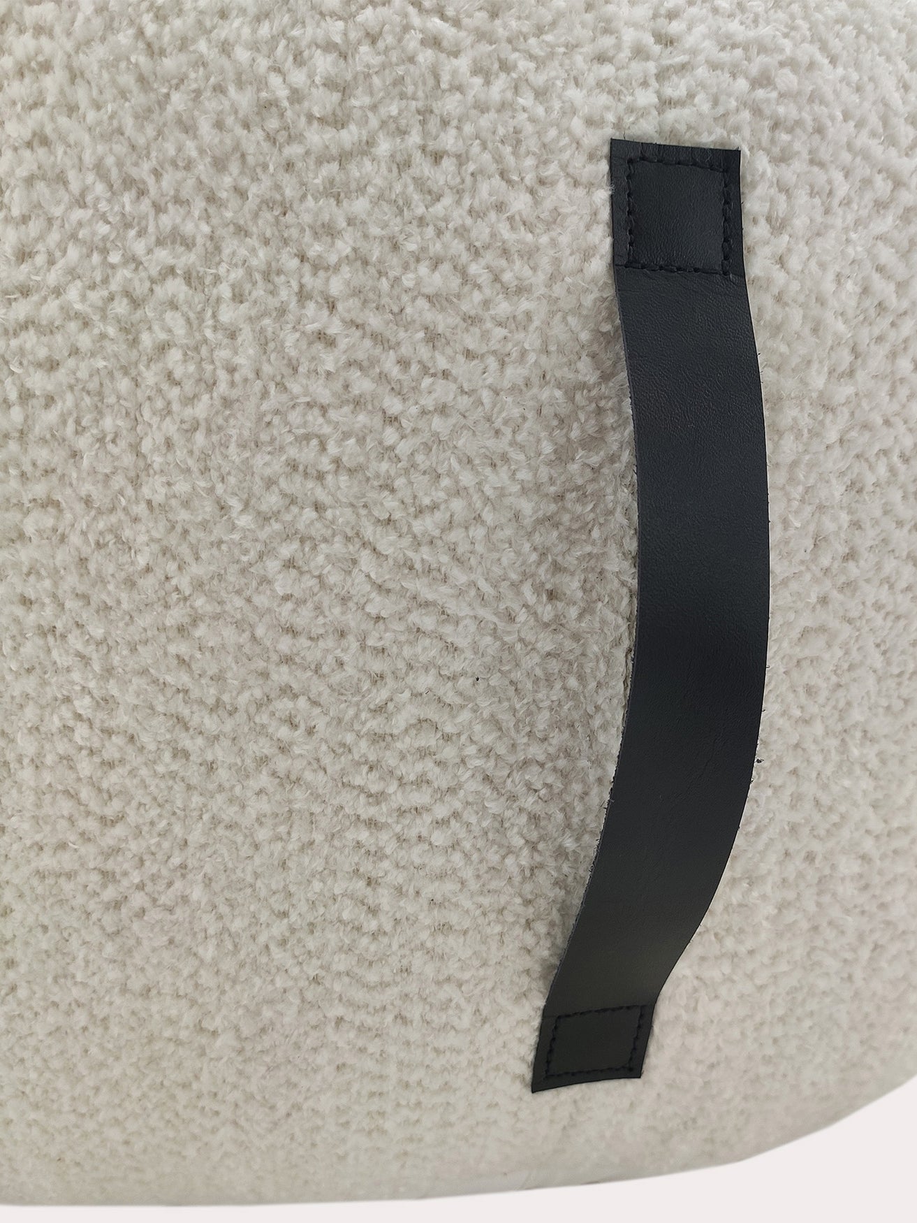 Close-up view of the handmade white cotton pouf showing fine woven texture and neat stitching details.