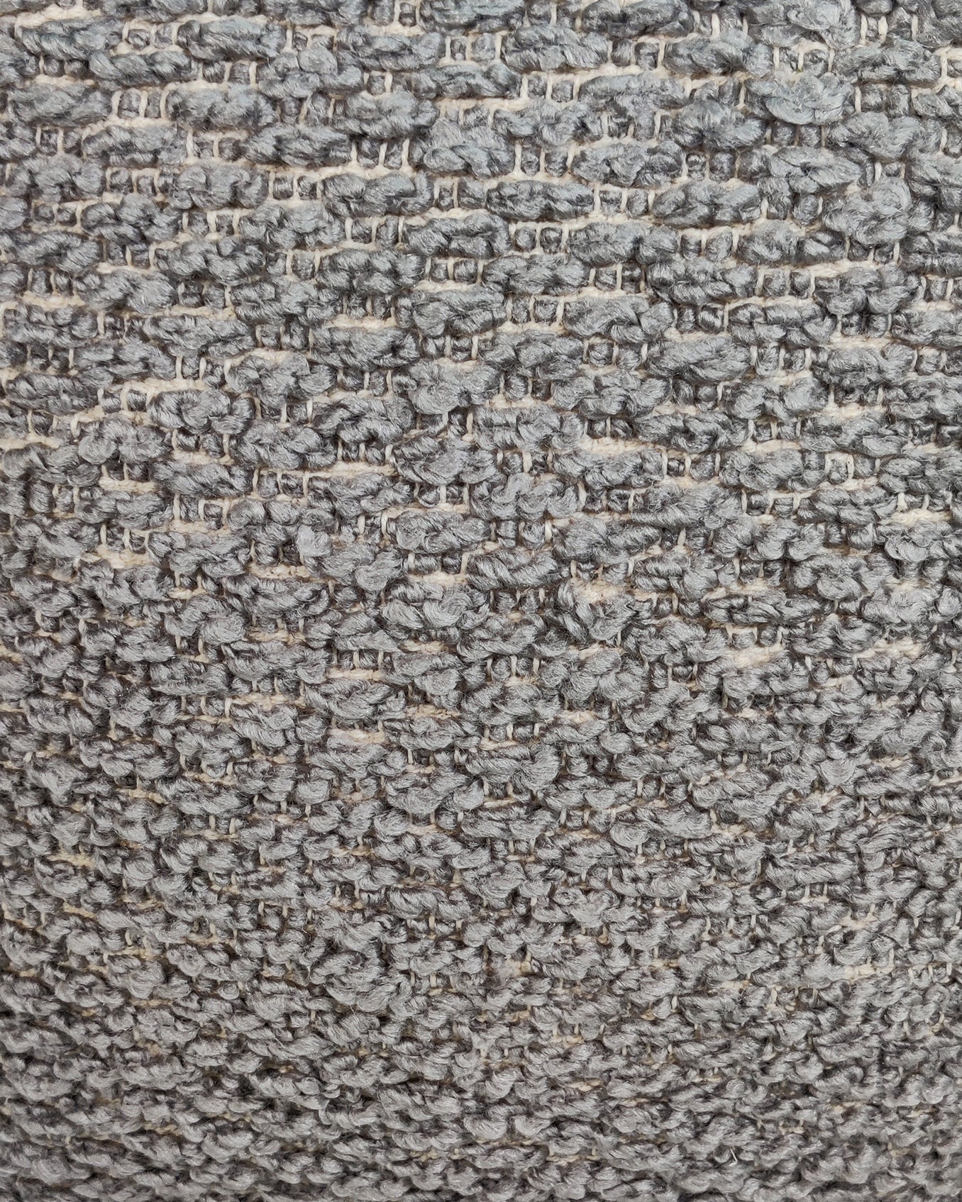 Detailed fabric texture of handmade grey polyester pouf with fine weave and soft cushion finish