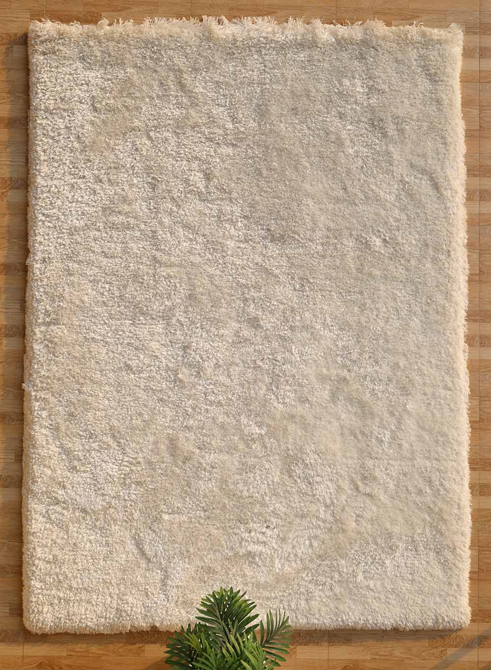 Handmade soft and comfort shaggy rug in white color, adding plush texture and warmth to any room.