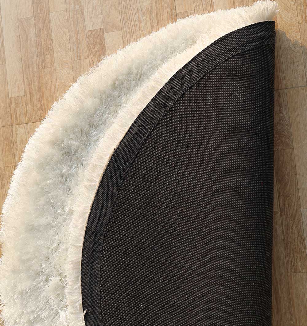 Backside of the round white shaggy rug, confirming the high-quality handmade weave for long-lasting durability.