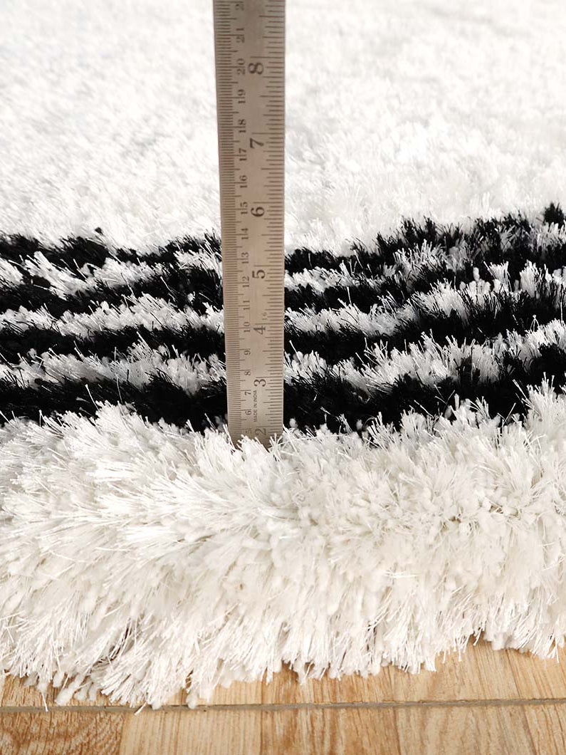 Side view clearly showing the thick, comforting pile height of the irregular shape shaggy rug.