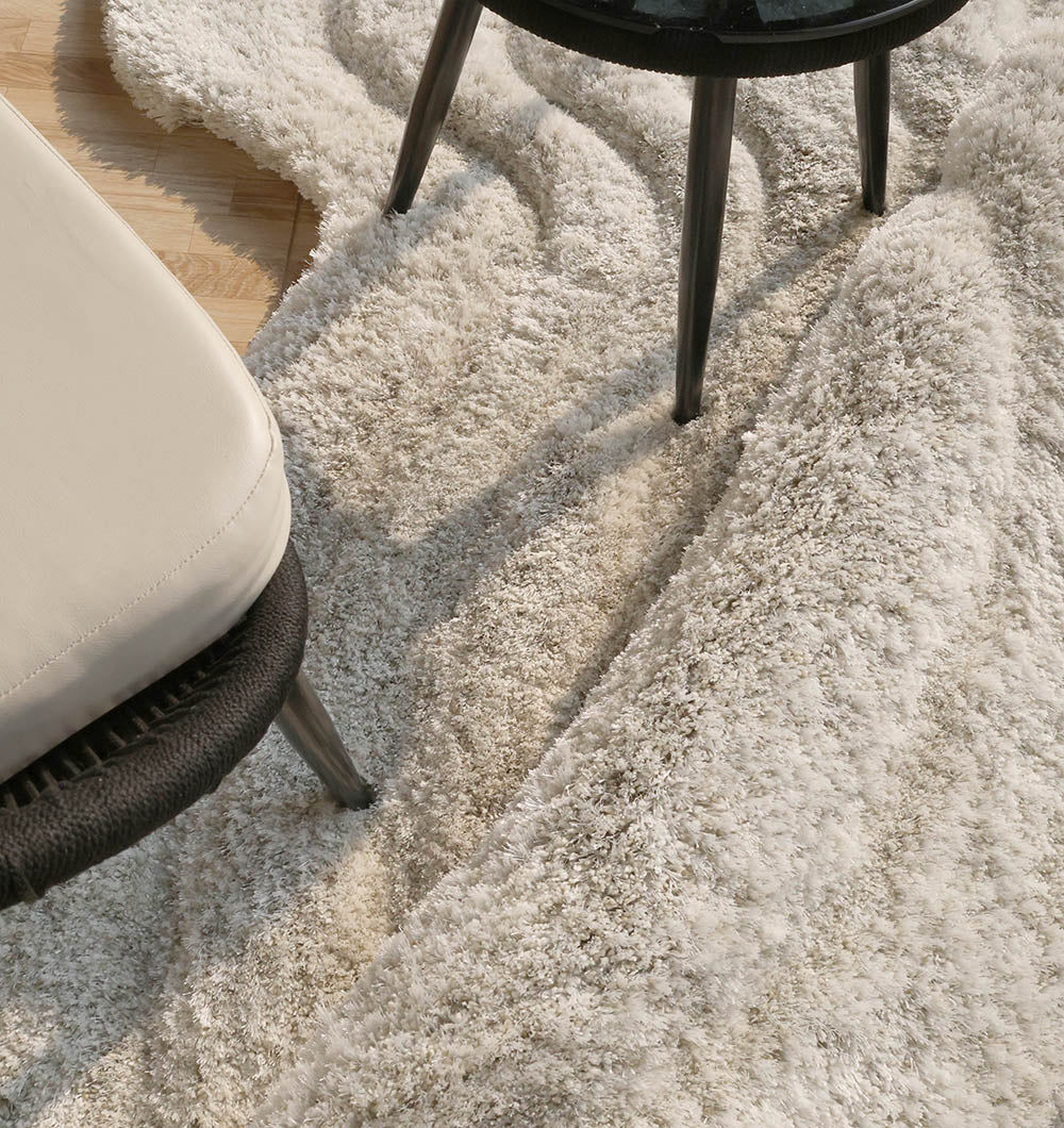 Close-up detailing the plush texture and superior softness of the handmade beige shaggy material.