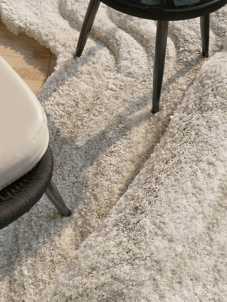 Close-up detailing the plush texture and superior softness of the handmade beige shaggy material.