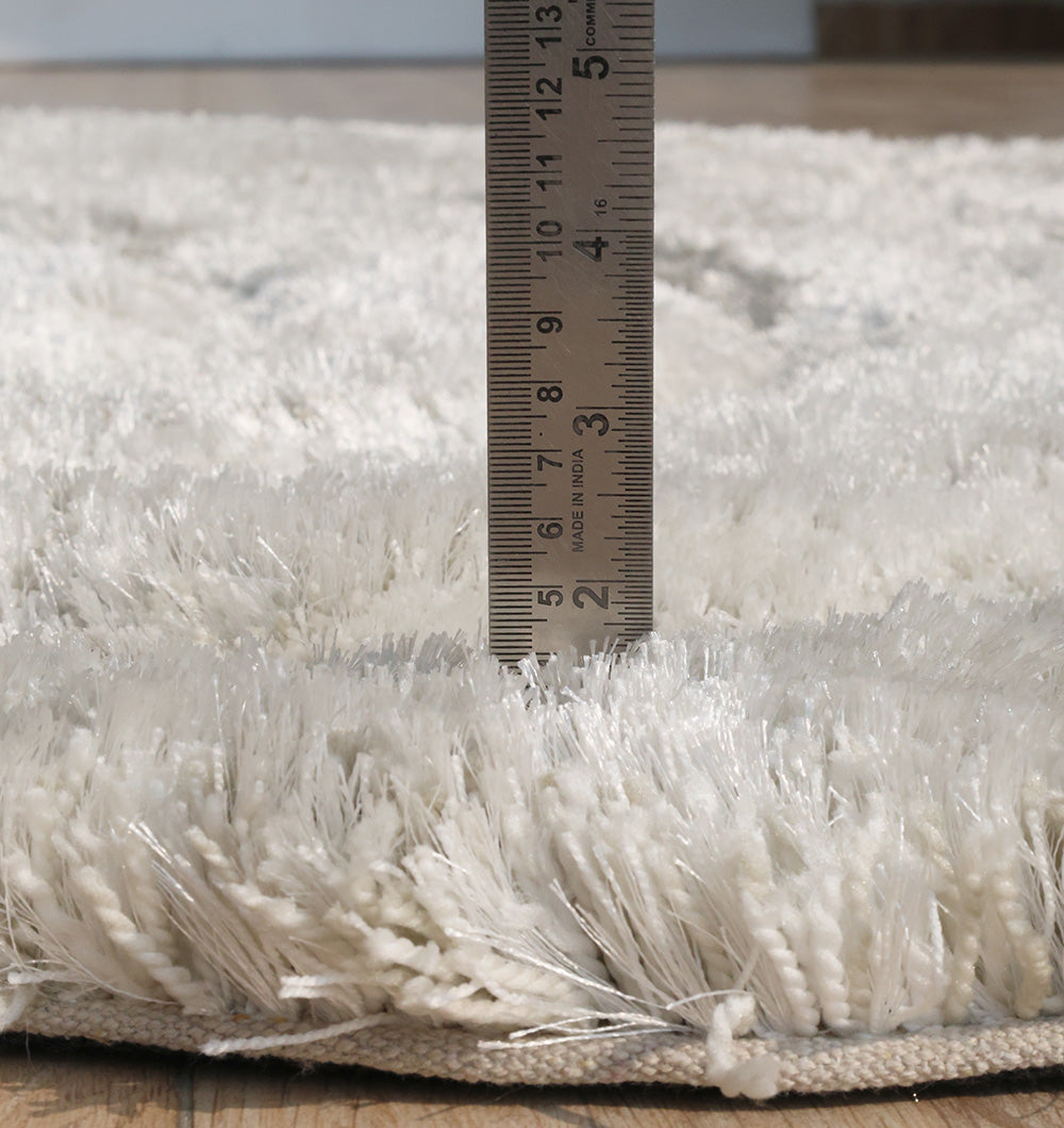 Side view clearly showing the thick, comforting pile height and handmade construction of the shaggy fibers.