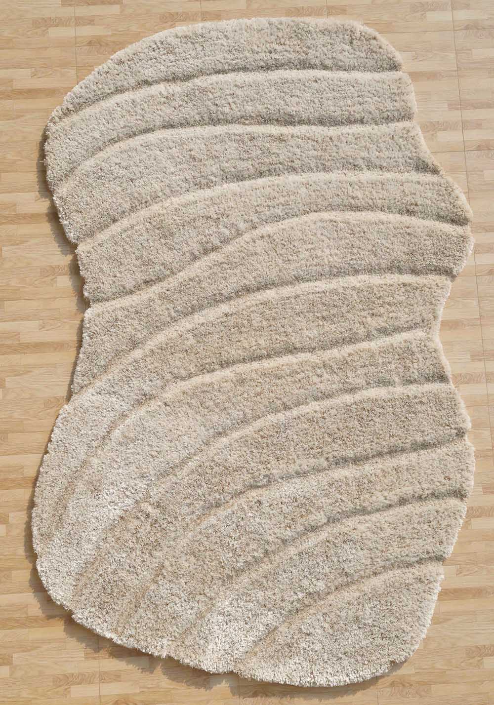 Beige spiral shape shaggy rug, featuring an irregular design and unique character for a sophisticated home.