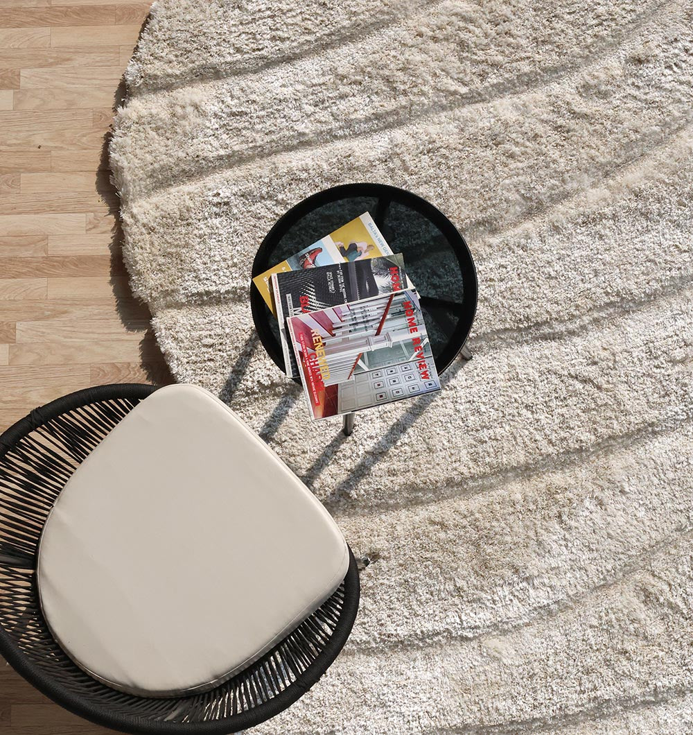 Overhead view of the entire shaggy rug, emphasizing the warmth and versatility of the unique spiral shape in a home setting.