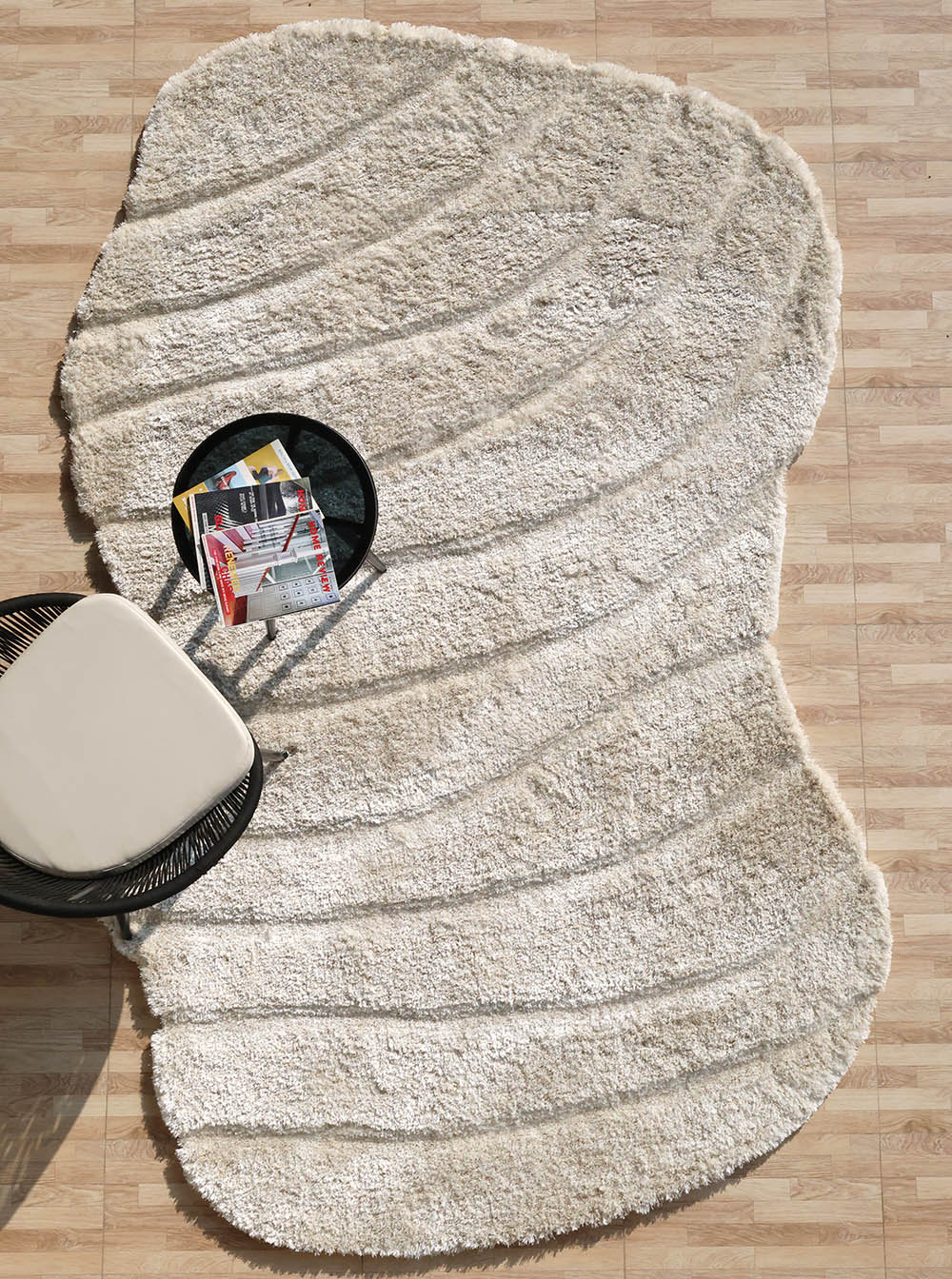 Beige spiral shape shaggy rug, featuring an irregular design and unique character for the home.