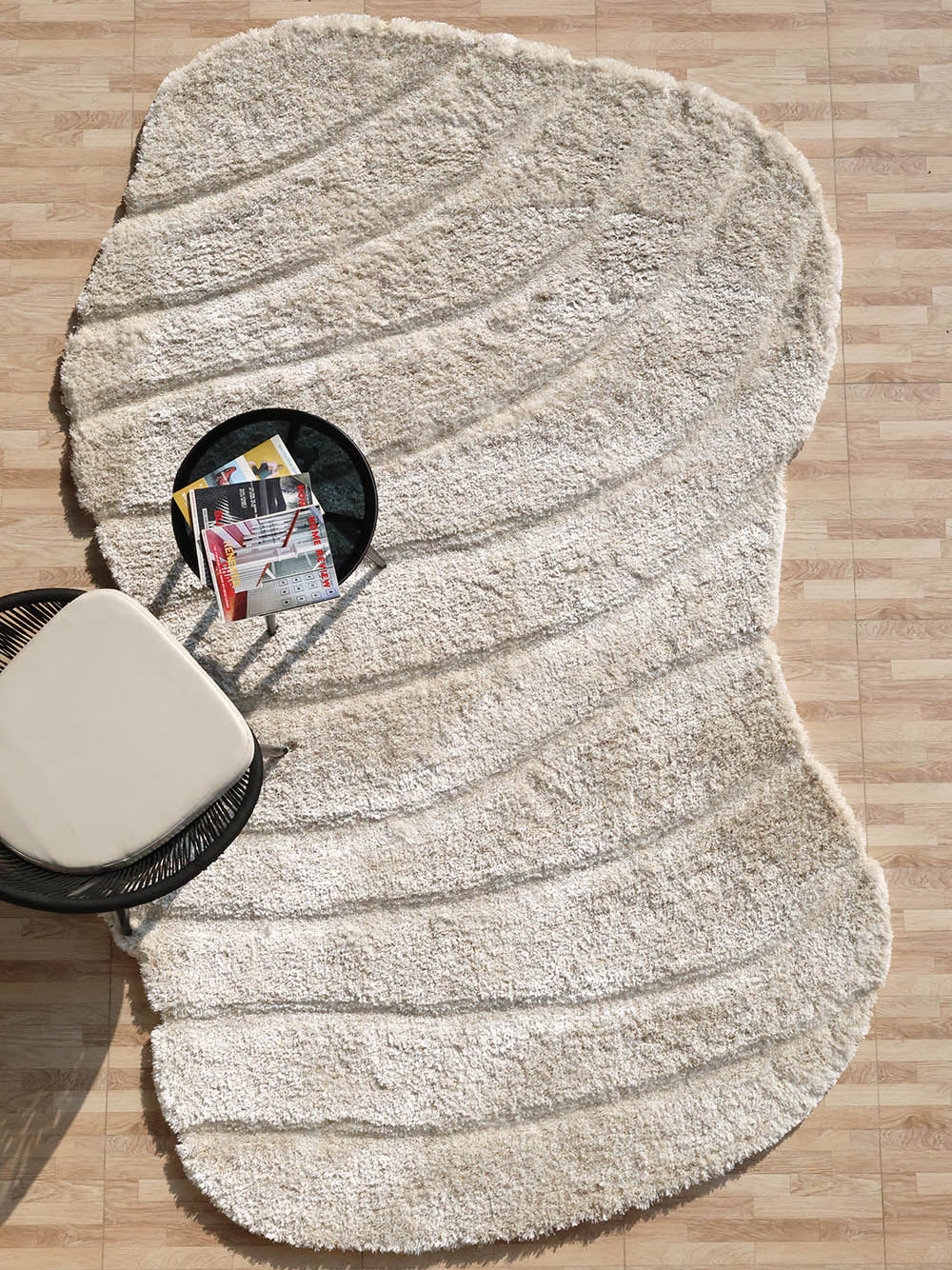 Beige spiral shape shaggy rug, featuring an irregular design and unique character for the home.