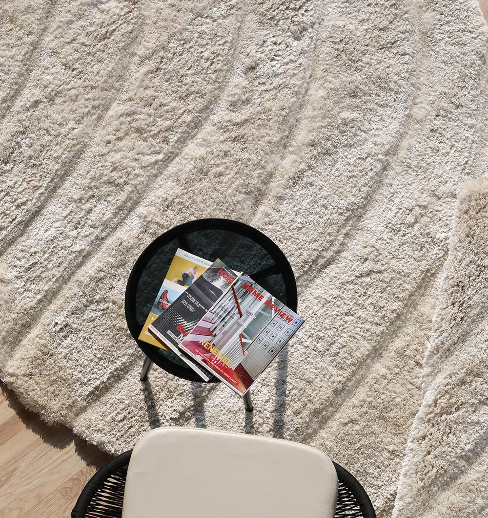 Top-down view showcasing the full irregular spiral shape and comforting beige color of the high-quality area rug.