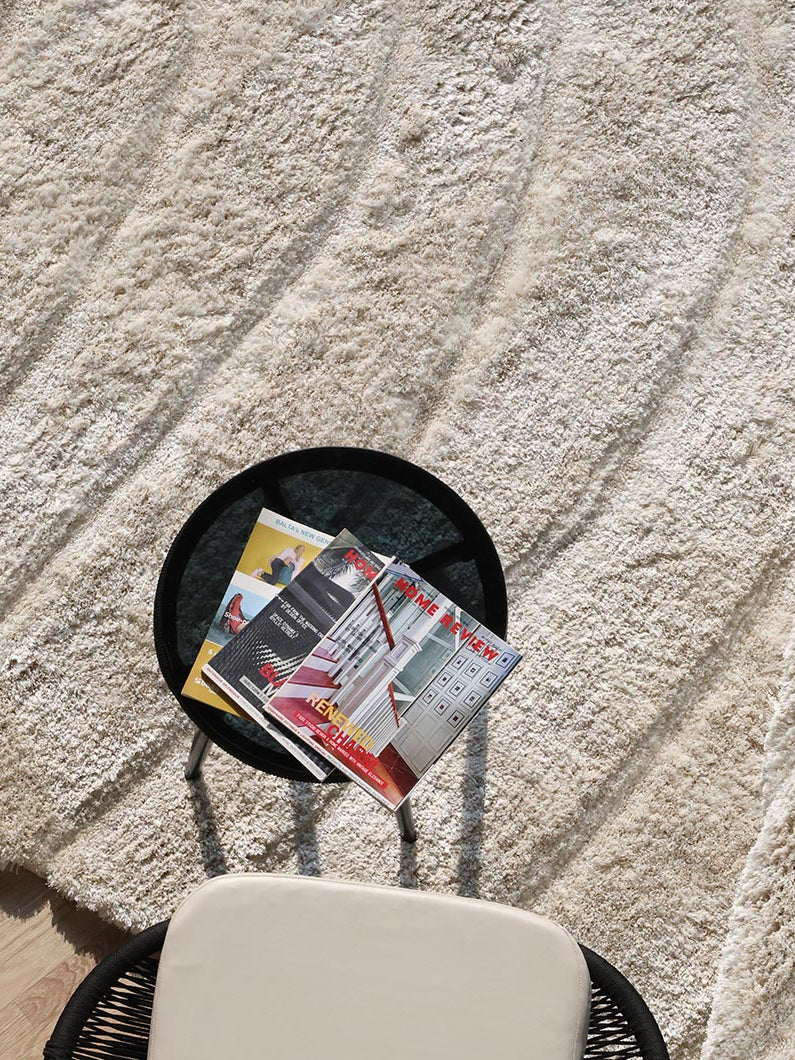 Top-down view showcasing the full irregular spiral shape and comforting beige color of the high-quality area rug.