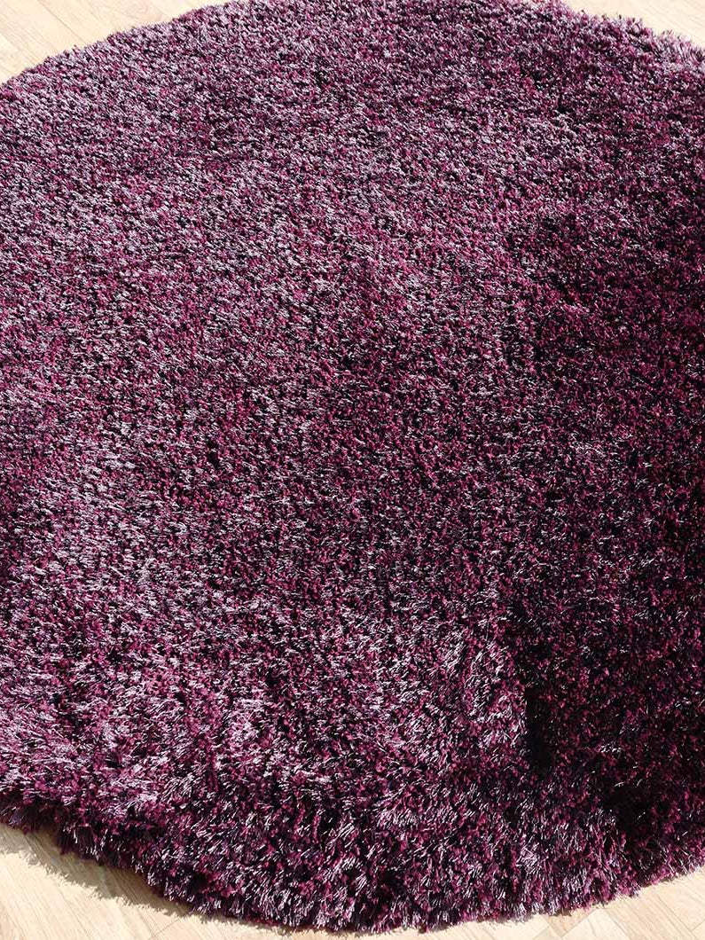 Side view of the irregular plush rug, showcasing the depth and thickness of the white modern shaggy pile.