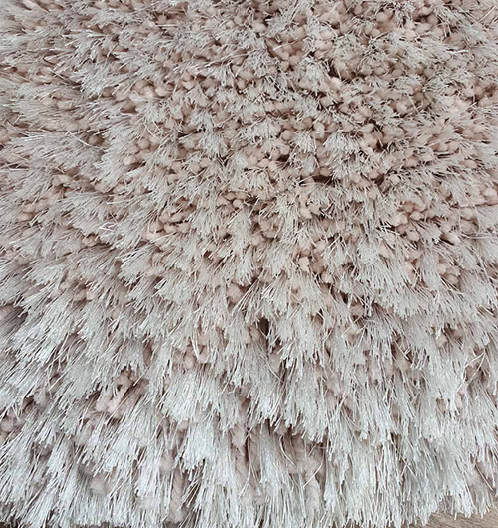 Close-up detailing the high density shag and soft feel underfoot provided by the resilient synthetic fiber blend.