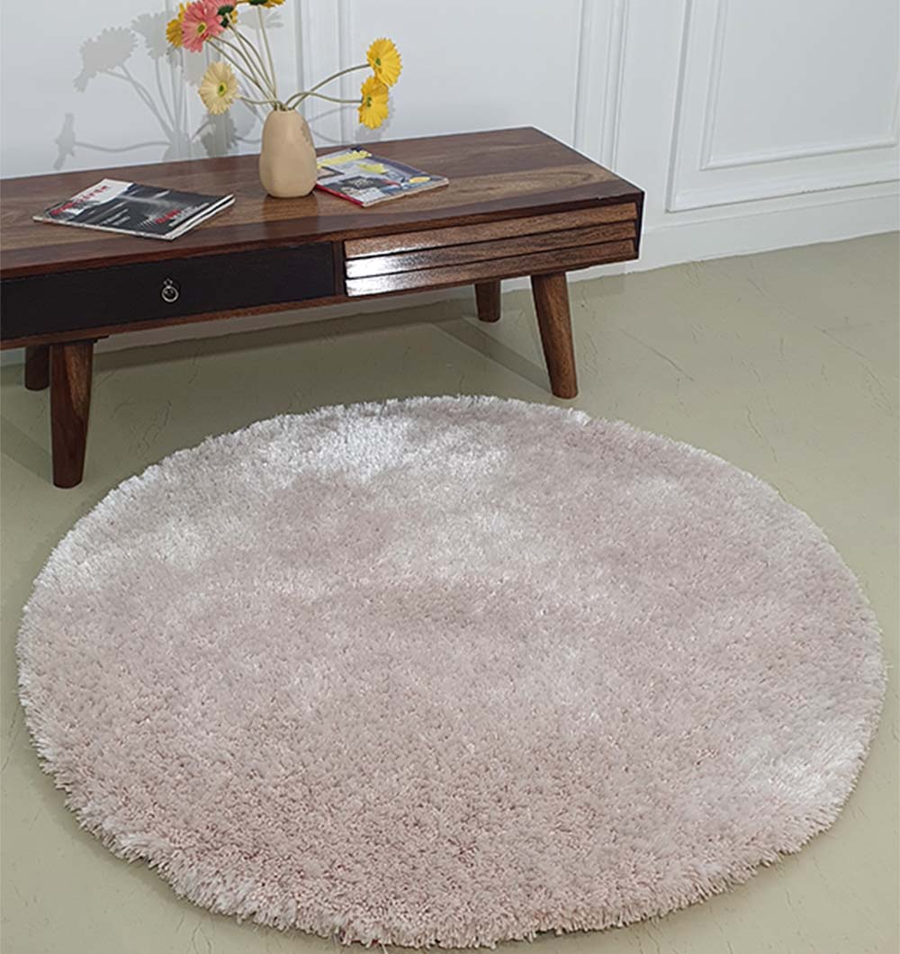 Circular natural beige rug acting as a floor comfort piece, adding a light color palette to the modern interior.