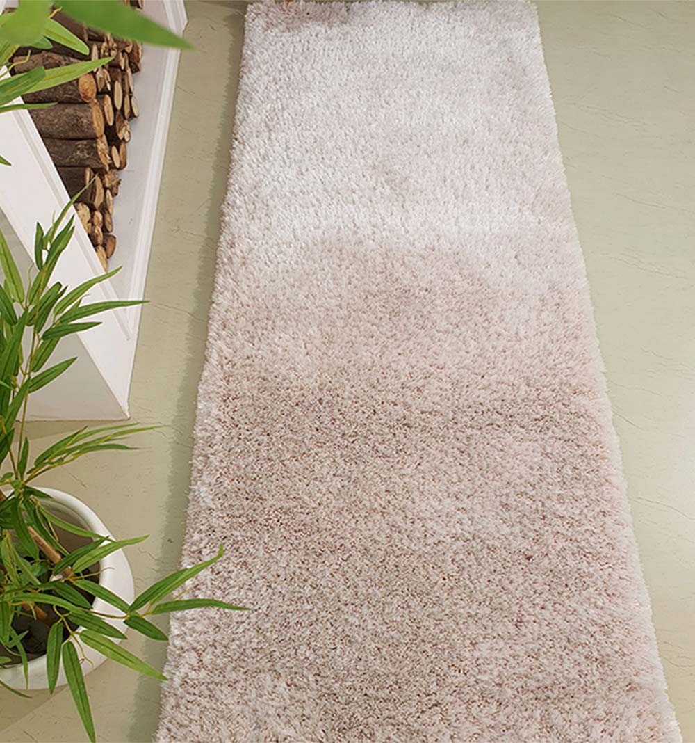 Natural beige shaggy runner rug placed in a hallway, offering a long, durable area accent for high-traffic paths.