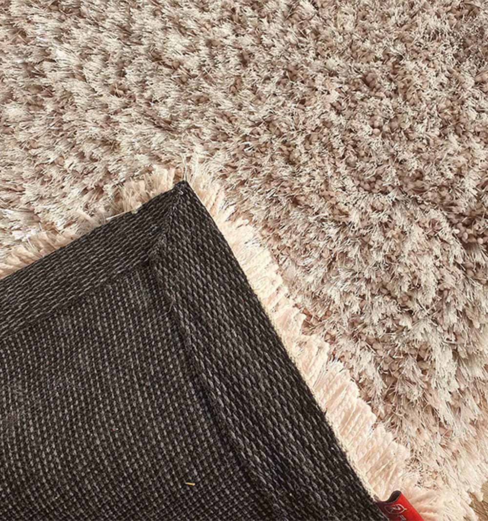 Backside of the runner rug, showing the reinforced backing and construction quality of the synthetic shag.