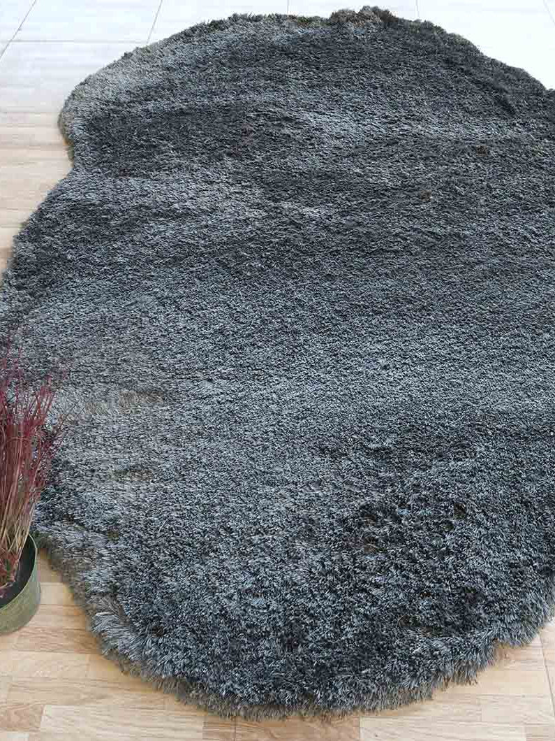 Dark grey irregular shaggy rug, a versatile floor accent designed for durability in high-traffic modern spaces.