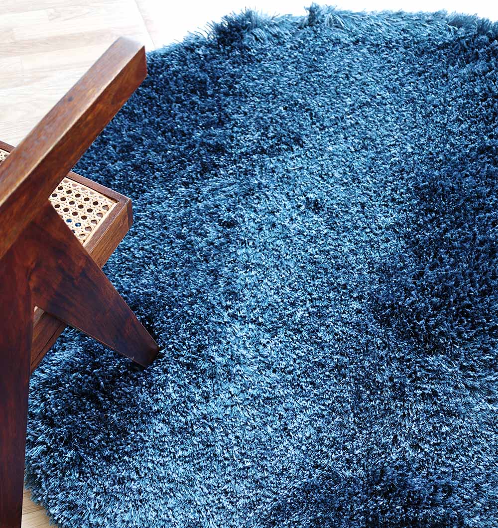 Top side perspective of the handmade blue rug, emphasizing its versatile irregular shape as a comfortable floor accent.