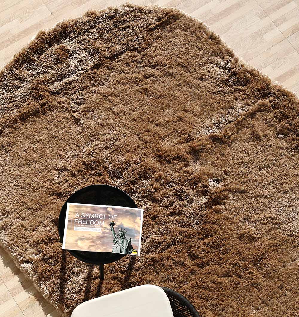 Detailed shot focusing on the softness and durability of the brown shaggy pile, made from the $80% polyester blend.