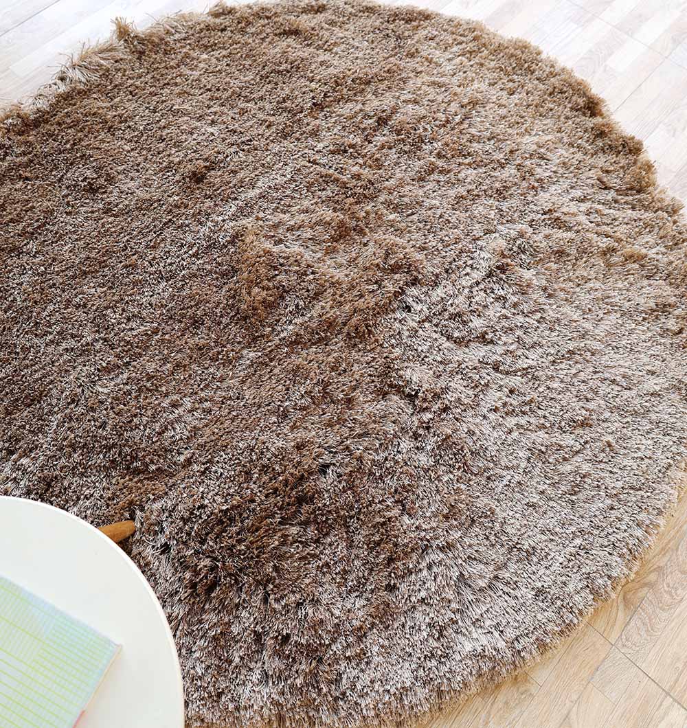 Overhead shot of the entire round area rug, showcasing the full shape and sophisticated look of the brown color.