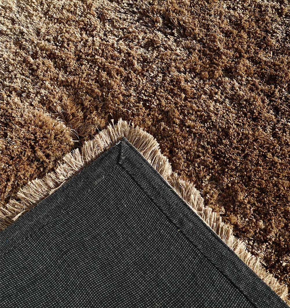 Backside of the rectangular brown plush rug, confirming the durable construction and shaggy material blend.