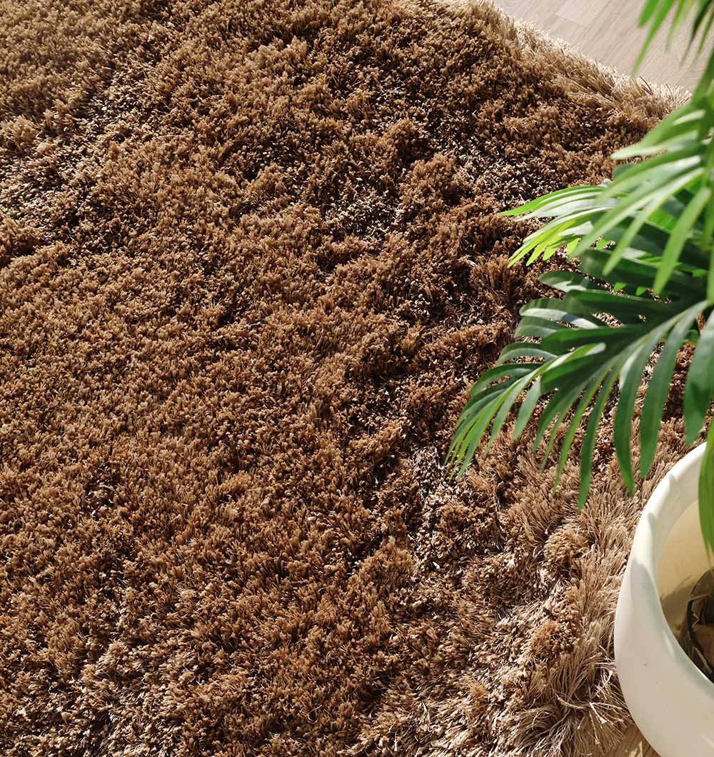 Side close-up of the rectangular rug's edge, clearly showing the thick pile height and handmade quality.