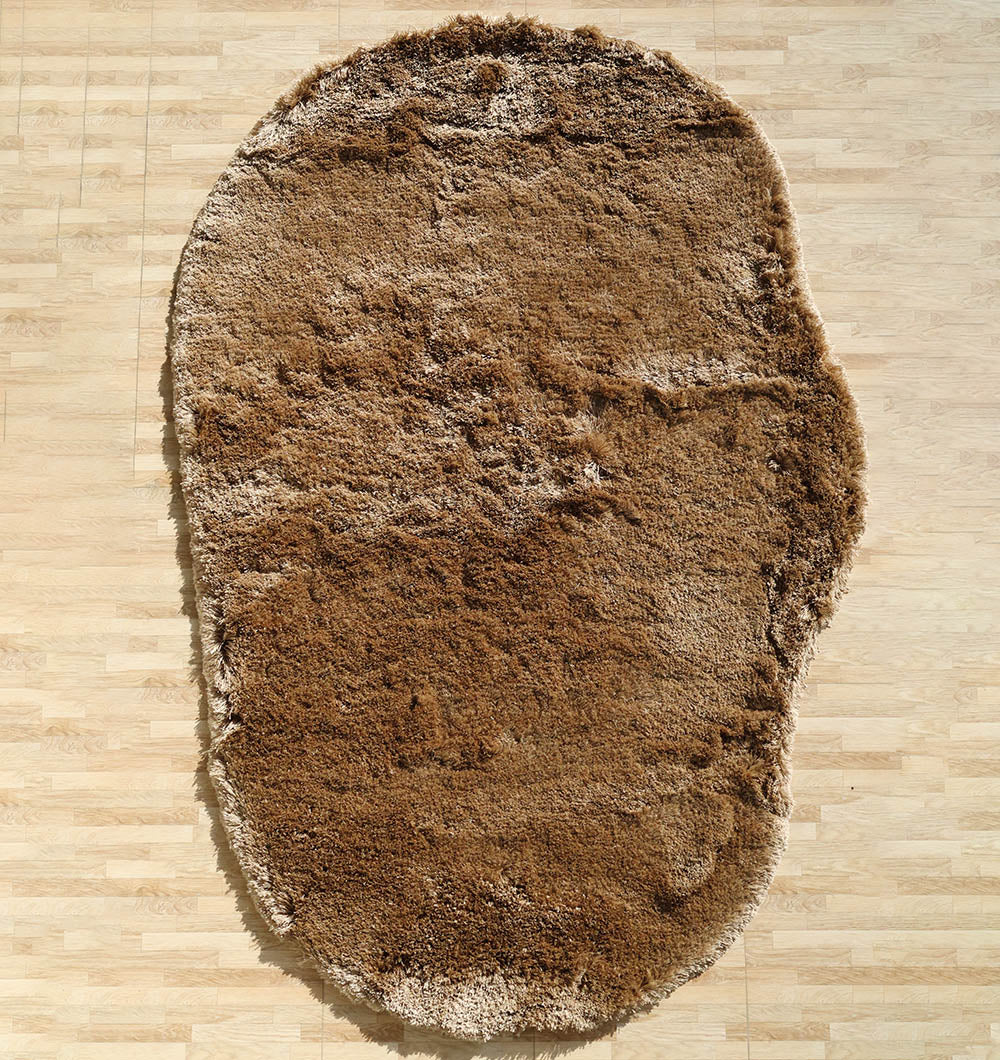 Irregular brown color plush rug, featuring a modern shaggy design that adds warmth and comfort to the home.