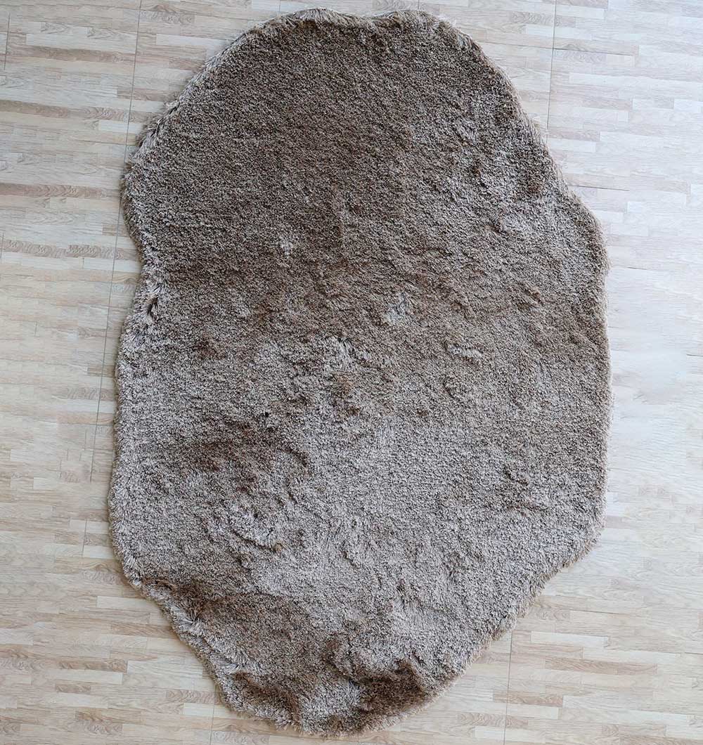 Handmade irregular brown plush rug featuring a modern shaggy design that brings warmth and comfort to the room.